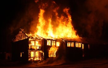 Night-time photo of a fire brigade or ambulance lights outside a building